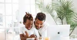 man and woman sitting on white couch